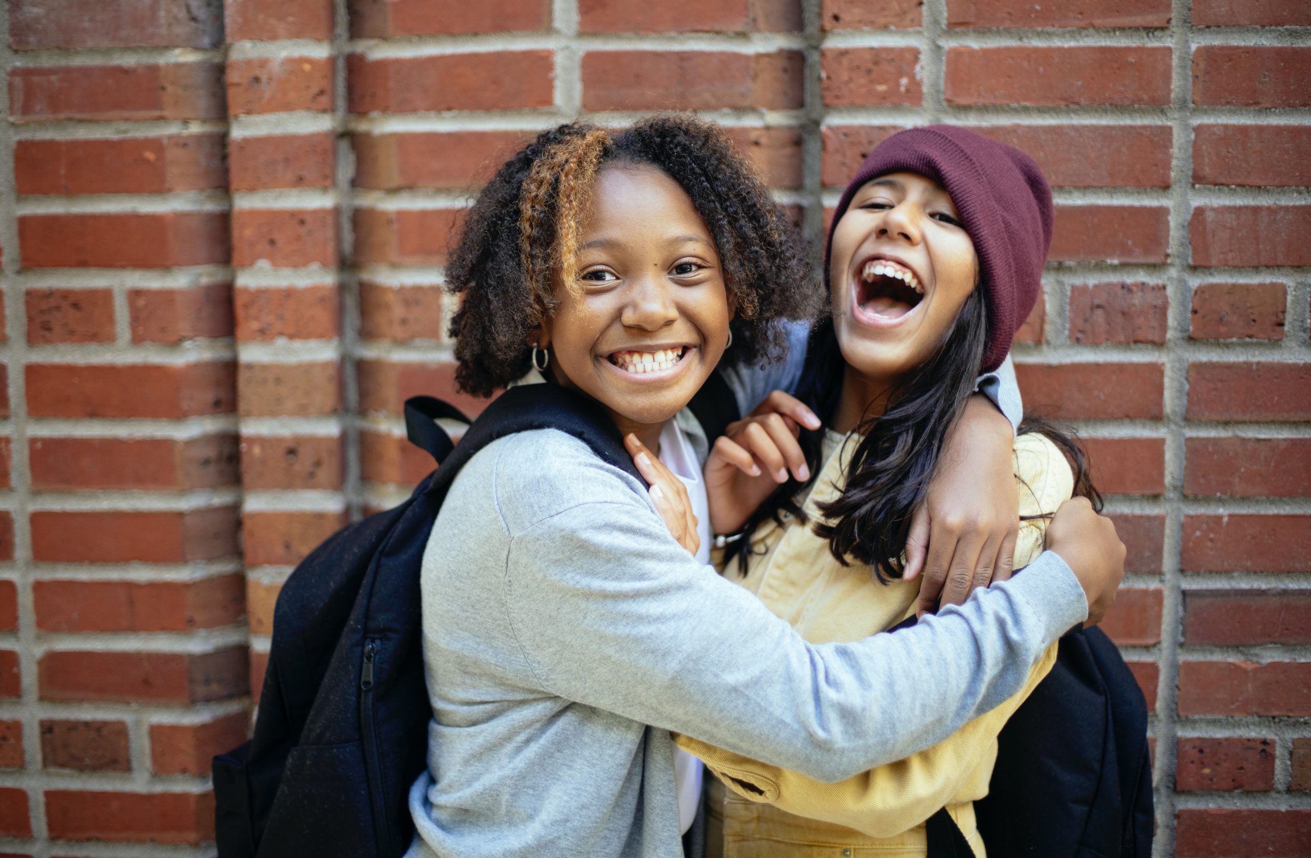 Two young people laughing and smiling.