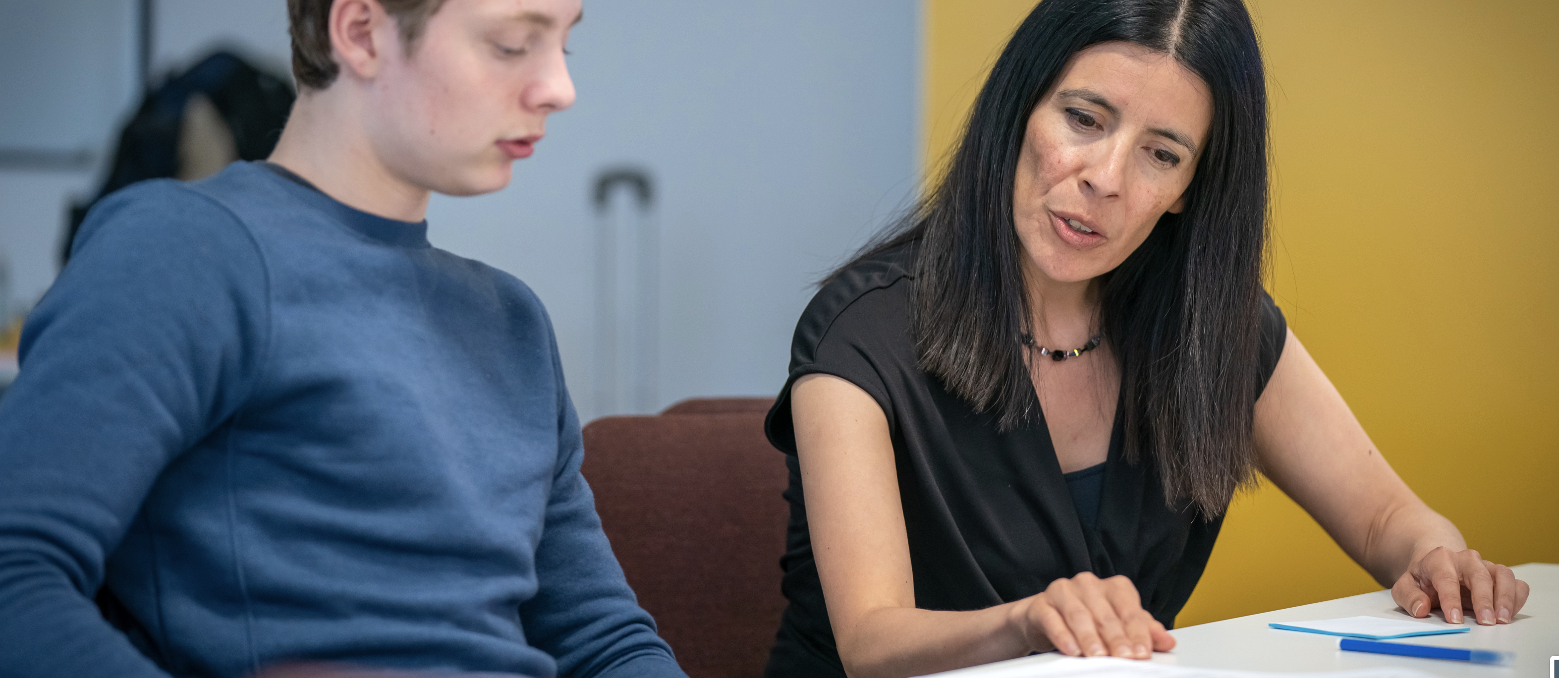 The Children's Commissioner discusses the content of a piece of paper with a young person